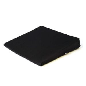 This is an image of a slimline sitting wedge it has a black cover and you can see it from a slight angle which shows what the surface you would sit on looks like and also the downwards slope of the angle of the wedge itself.