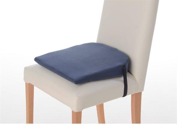 A blue Putnams 8 degree sitting wedge on a beige dining room chair. The strap is placed around the sitting surface to hold it in place.