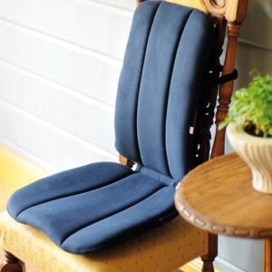 A blue Sissel full dorsaback placed on top of an ornate high backed dining room chair. You can see the contours to support your legs and lower back.