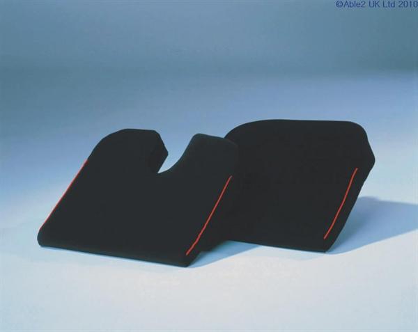 An image of both the coccyx cut out and standard Harley desinger wedges. Both have black covers and red piping along the side.