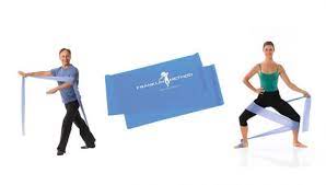 In the middle is the blue franklin resistance band. On the left is Eric Franklin stood with one leg in front of the other (it is probably a ballet position) his arms are outstretched in front of him and the long blue resistance band draped over his arms. On the right is a lady who is in a wide legged squat the resistance band is curled around from her right foot to her left upper calf to her right thigh then behind her body and she is holding it in her left hand.