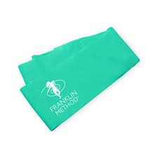 A Franklin method green resistance band folded over on itself. In white are the words franklin method and there is the image is a lady dancing also in white.