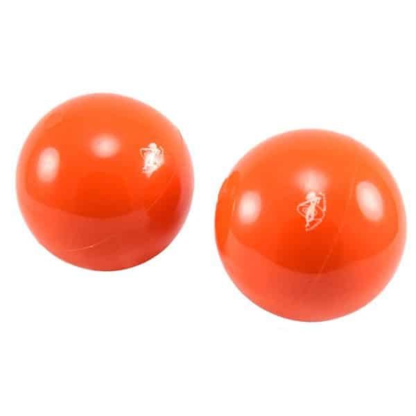 This is an image of two orange franklin pilates balls they are at an angle. On the front you can see the Franklin Pilates logo which is white and looks like someone dancing with their arms swirling