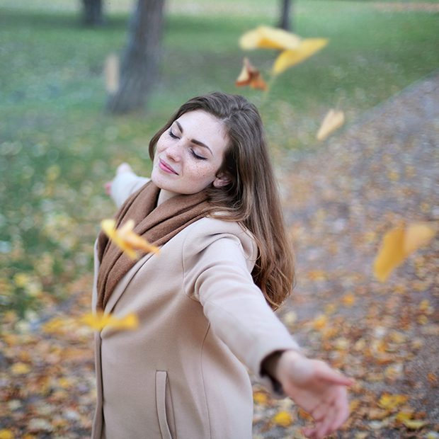 Lady-enjoying-the-autumn-leaves-taking-a-break-ensuring-she-avoids-back-pain-at-work