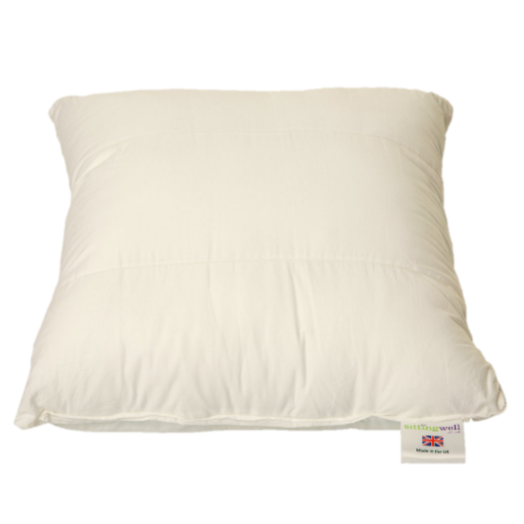 Sittingwell Sofa Back Support, This image is the front of a Sittingwell sofa back support cushion it is placed flat so you can see it from the top. On the bottom right is the product label showing it is a Sittingwell product and made in the UK. The cushion iteself just looks like a cushion before you have put it inside the cushion cover which is the beauty of the product, it doesn't look like an orthopaedic device and yet it is a back support.
