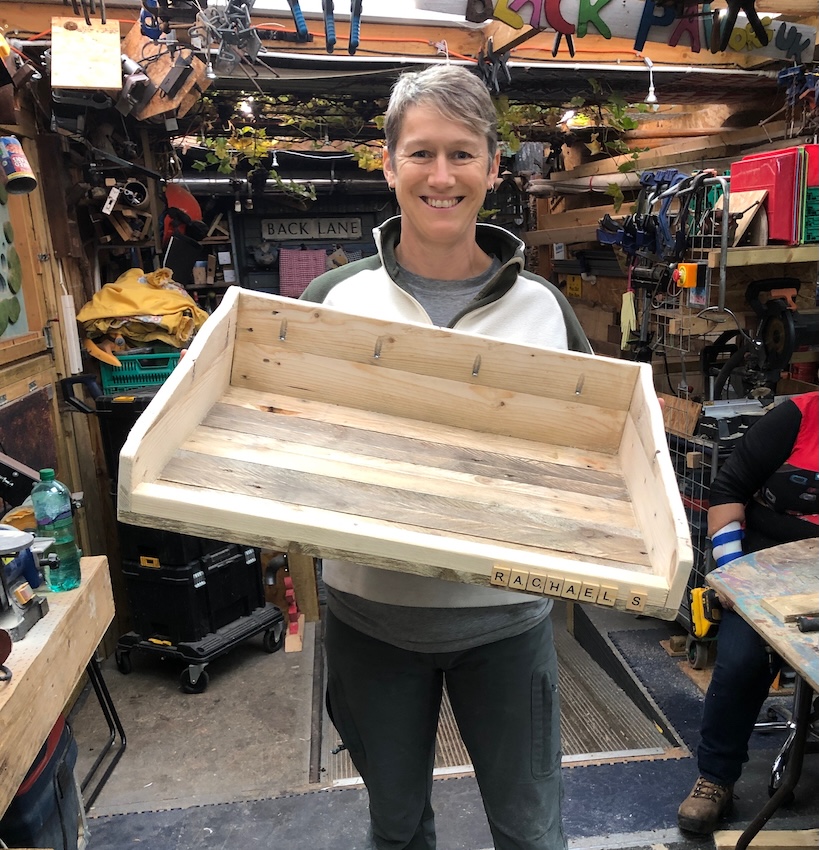 Lorna Kennard-Wall Pallet creation Lorna from Sittingwell holding her potting tray made from pallet wood